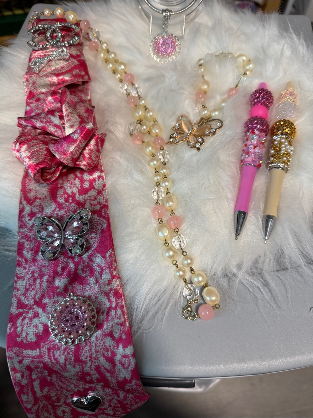 Pink Patterned Junk Tie with Sparkling Brooches and Pearl Necklace